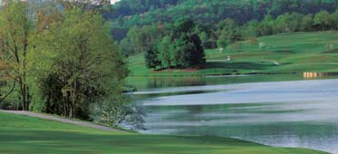 Photo of reservoir and shoreline with trees and hills