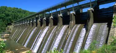 Photo of Great Falls dam with water flowing over spillways