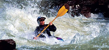 photo of kayaker in whitewater